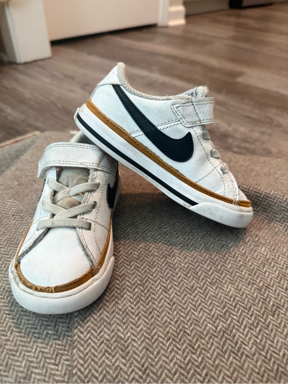 Nike Kids White Sneakers with Black Swoosh and Brown Accent